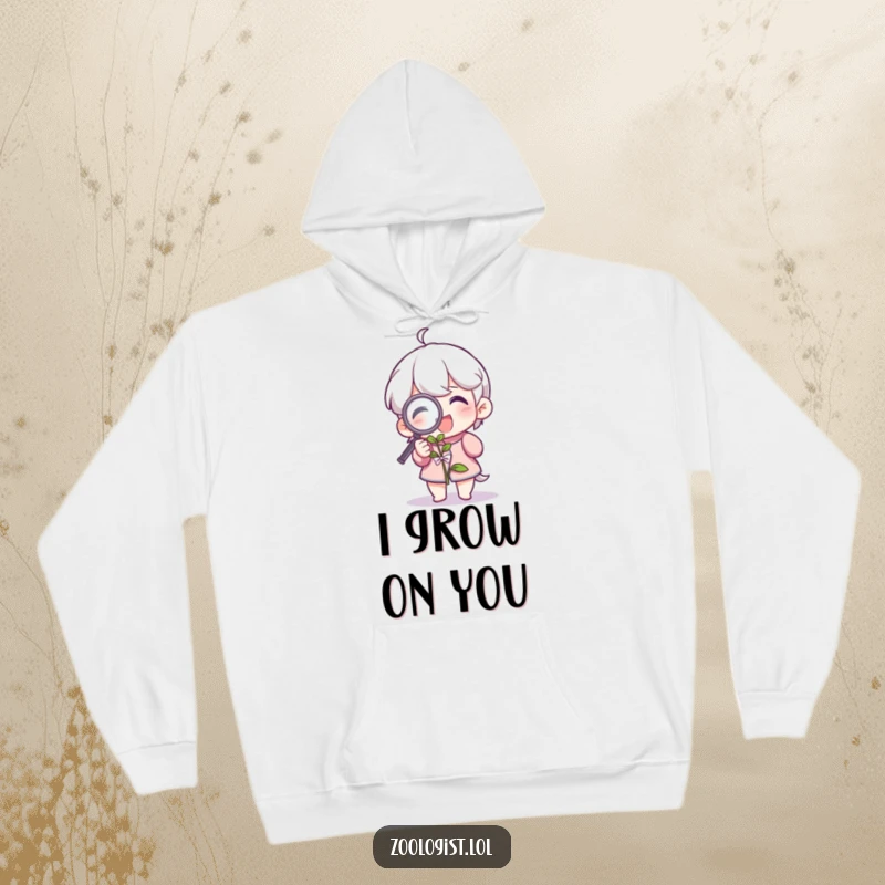 Funny hoodie featuring a joyful character examining a plant with a magnifying glass, a perfect humorous gift for plant enthusiasts.