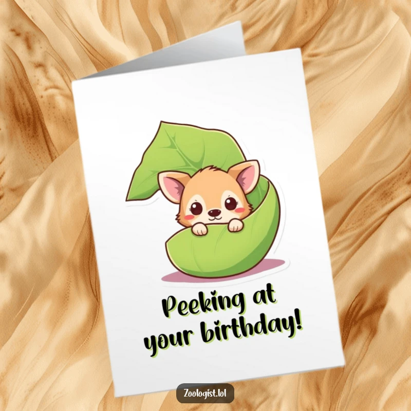 Funny Free Printable Birthday Card: Curious animal character peeking out playfully from behind a giant, lush green leaf.