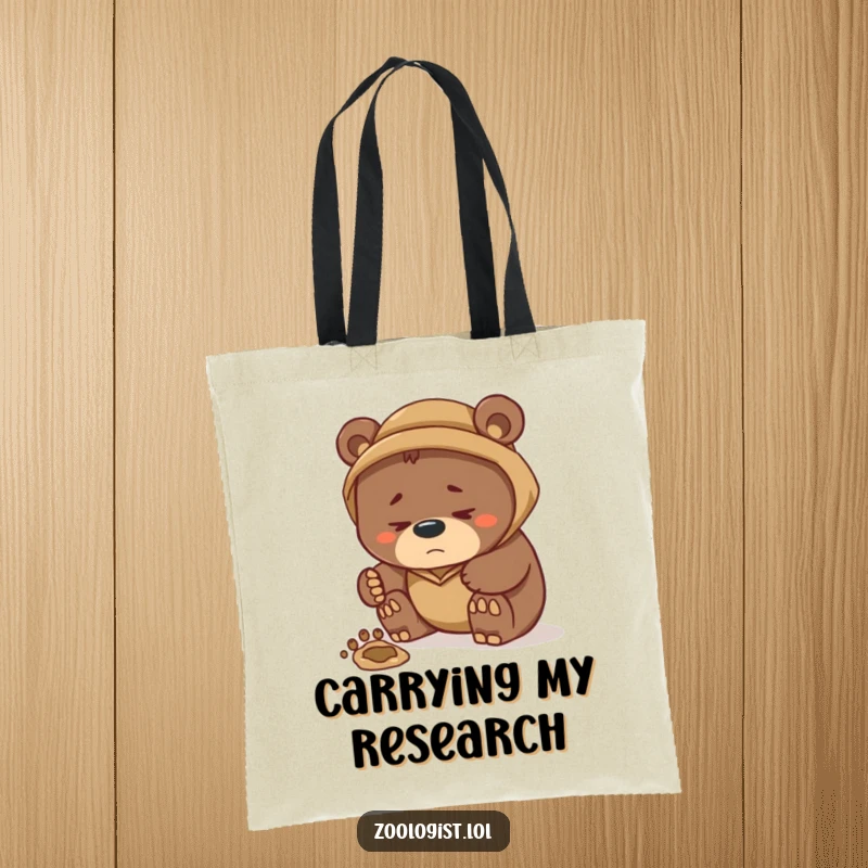 Funny tote bag displaying a thoughtful bear zoologist carefully inspecting a footprint, highlighting a humorous approach to investigative wildlife observation.
